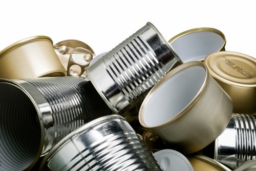 Overflowing commercial waste bins with signage